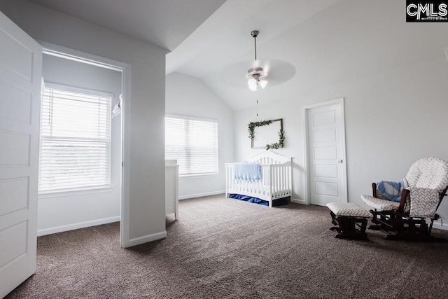 bedroom featuring baseboards, carpet, a nursery area, and vaulted ceiling