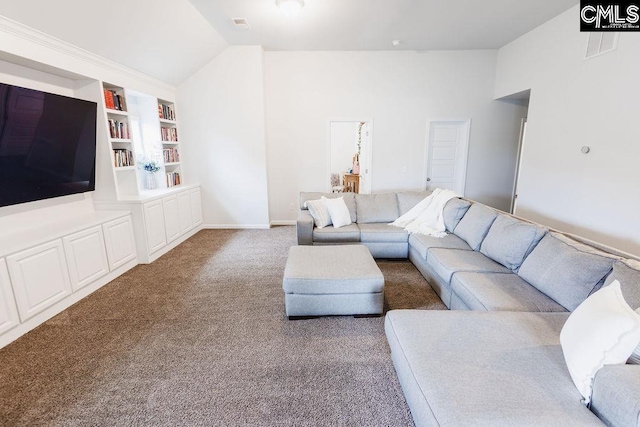 carpeted living area with baseboards, visible vents, built in shelves, and lofted ceiling