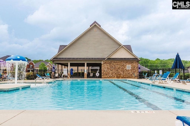 community pool featuring fence and a patio area