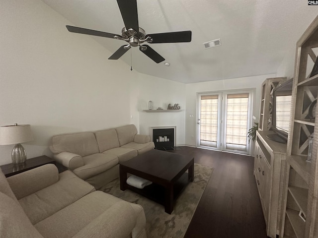 living room featuring a ceiling fan, dark wood-style flooring, visible vents, a fireplace with flush hearth, and baseboards