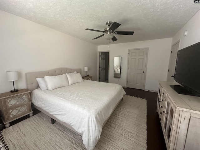 bedroom featuring a textured ceiling and ceiling fan