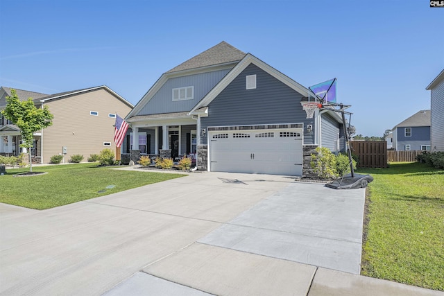 craftsman-style home with a front lawn, fence, covered porch, and concrete driveway