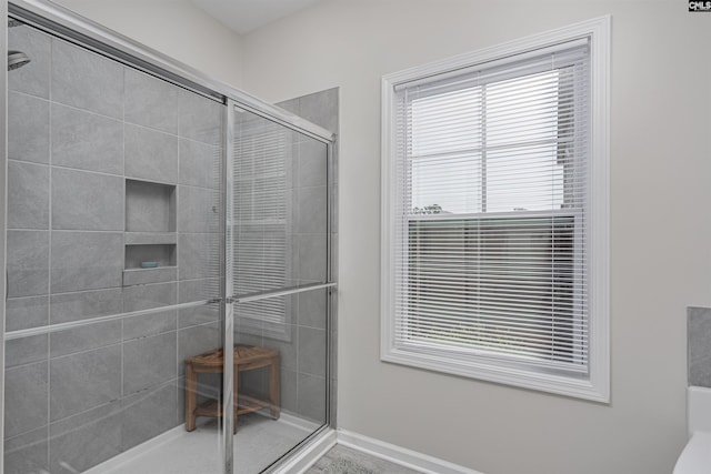 full bath featuring baseboards and a stall shower