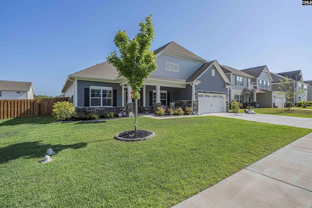 view of front of house with fence, driveway, stone siding, and a front lawn