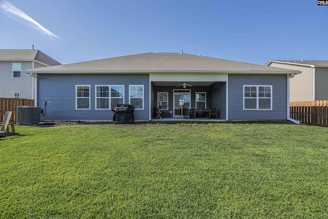 rear view of house featuring central AC, fence, a ceiling fan, a patio area, and a yard