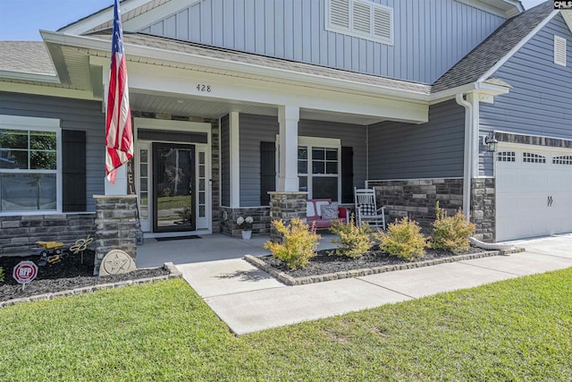 property entrance with a porch, board and batten siding, and stone siding