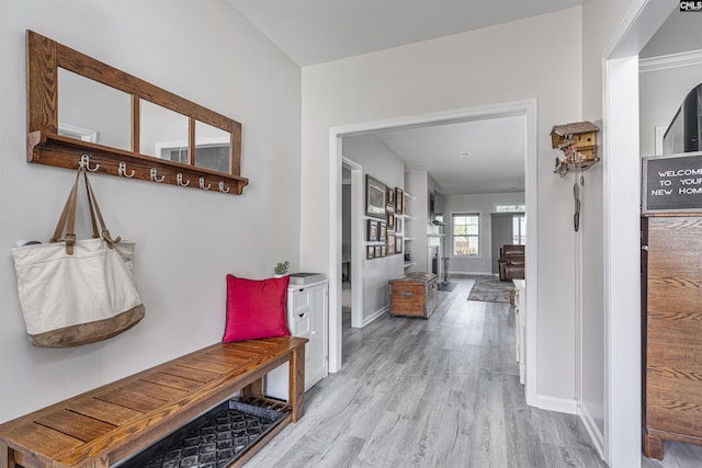 mudroom featuring baseboards and wood finished floors