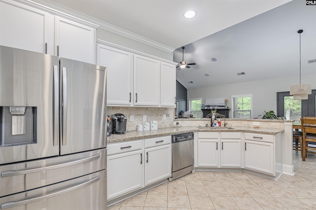 kitchen featuring a peninsula, light tile patterned flooring, tasteful backsplash, a ceiling fan, and appliances with stainless steel finishes