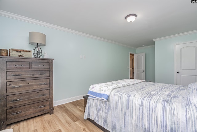 bedroom with crown molding, baseboards, and light wood-style flooring