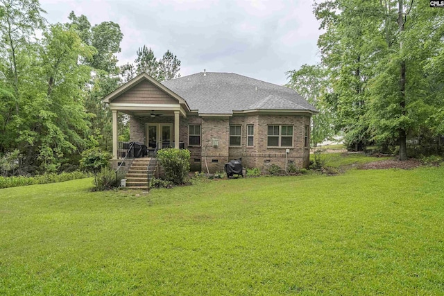 back of house featuring crawl space, a ceiling fan, french doors, a lawn, and brick siding
