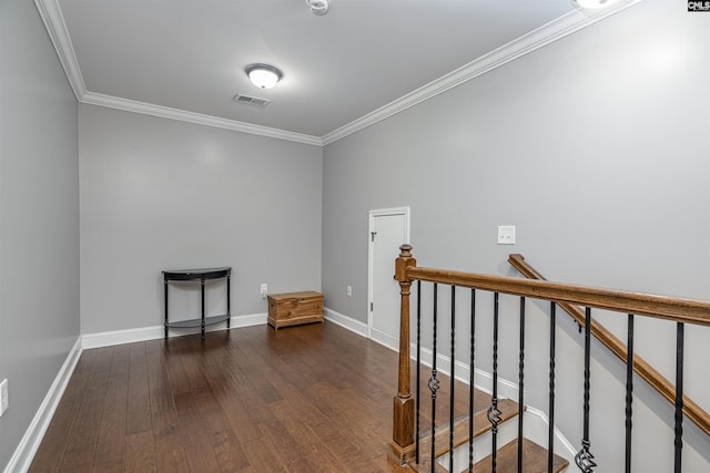 interior space featuring visible vents, ornamental molding, baseboards, and hardwood / wood-style floors