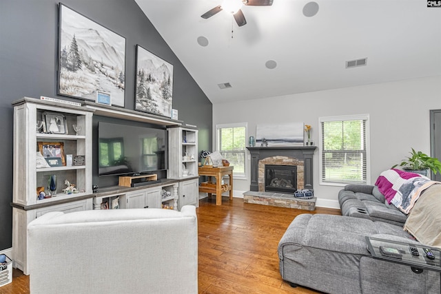 living room featuring plenty of natural light, a ceiling fan, wood finished floors, and visible vents