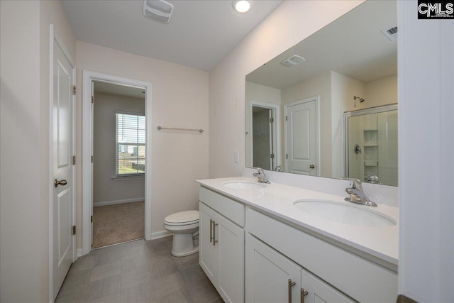bathroom featuring a sink, baseboards, a shower stall, and visible vents