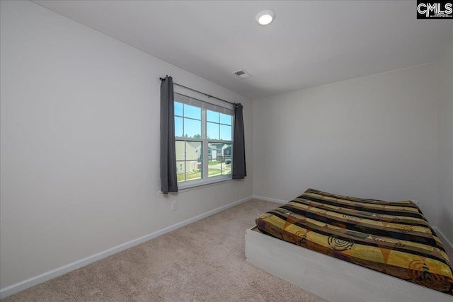 unfurnished bedroom with carpet floors, baseboards, and visible vents