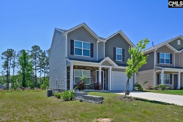 view of front facade with an attached garage, driveway, central AC, and a front yard