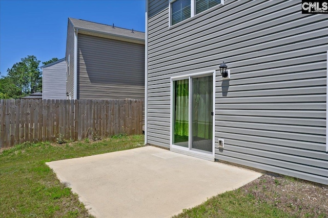 view of patio featuring fence