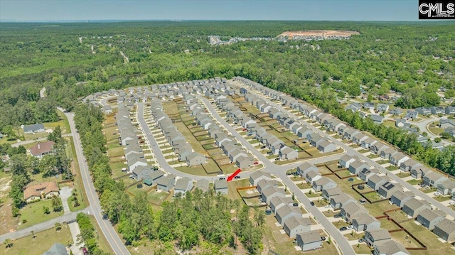 birds eye view of property featuring a residential view and a forest view