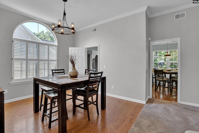 dining space with visible vents, a notable chandelier, and a wealth of natural light
