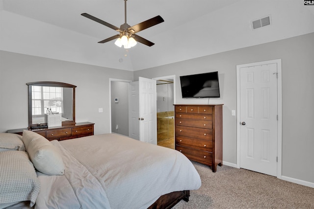 bedroom featuring light colored carpet, a ceiling fan, baseboards, ensuite bathroom, and visible vents