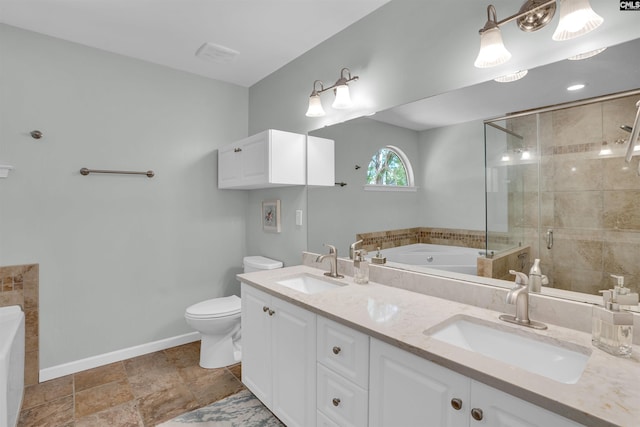 full bathroom with a garden tub, a sink, baseboards, and toilet