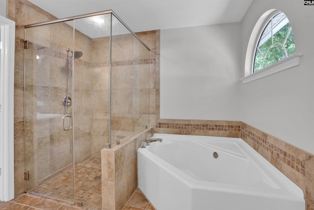 bathroom with a garden tub and a stall shower