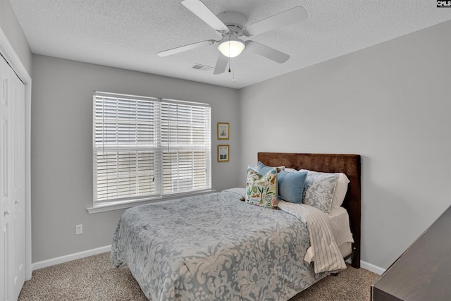 bedroom featuring a closet, carpet, ceiling fan, and multiple windows