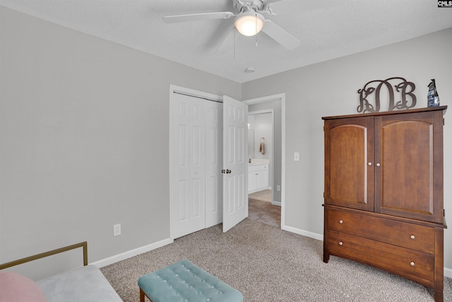 bedroom with baseboards, ceiling fan, light carpet, and a closet
