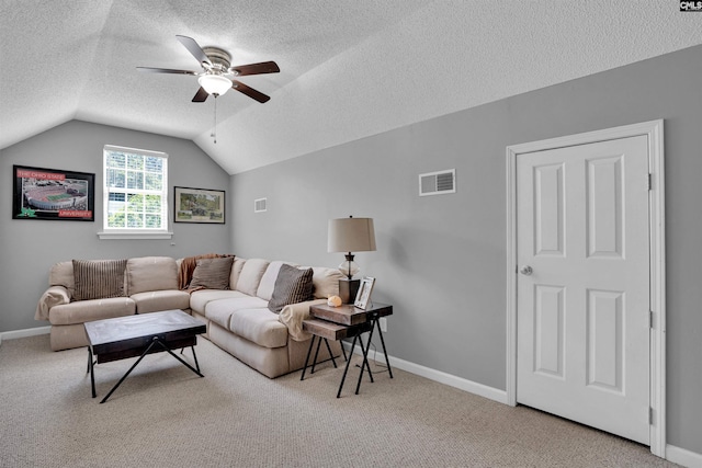 living room featuring visible vents, ceiling fan, a textured ceiling, carpet, and vaulted ceiling