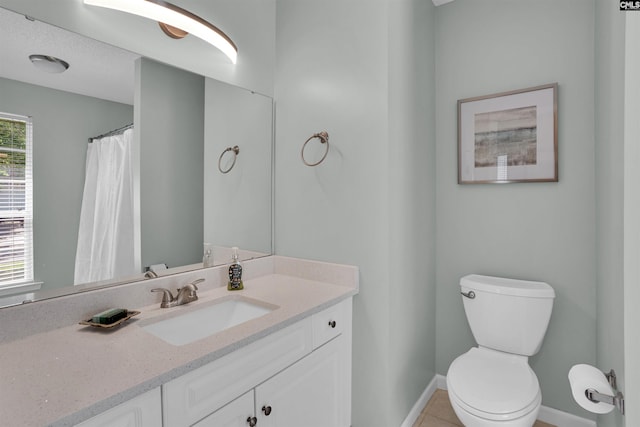 full bath with baseboards, tile patterned floors, toilet, and vanity