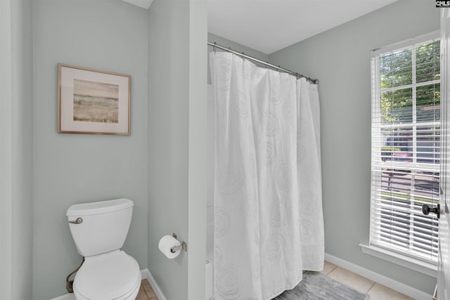 full bathroom with baseboards, tile patterned floors, toilet, and a shower with curtain