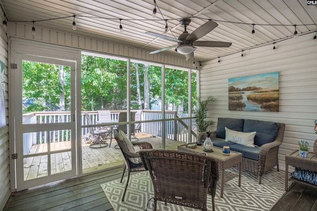 sunroom featuring an outdoor living space, a ceiling fan, and outdoor dining space