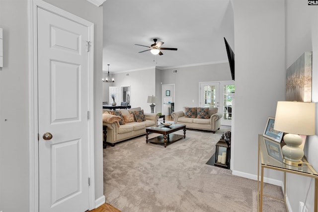 carpeted living room featuring crown molding, baseboards, ceiling fan with notable chandelier, and visible vents