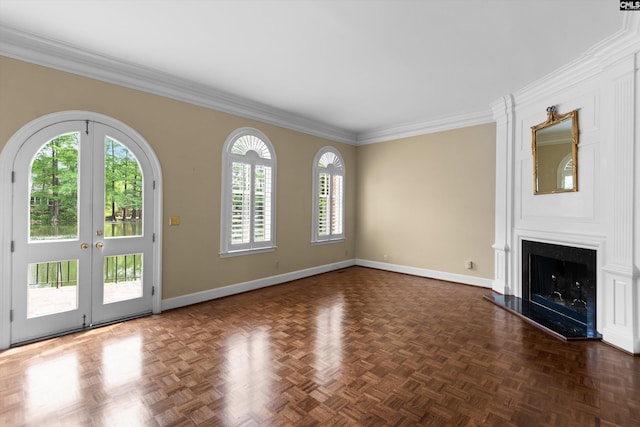 unfurnished living room with crown molding, baseboards, french doors, and a large fireplace