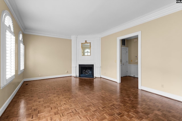 unfurnished living room featuring crown molding, baseboards, a fireplace, and visible vents