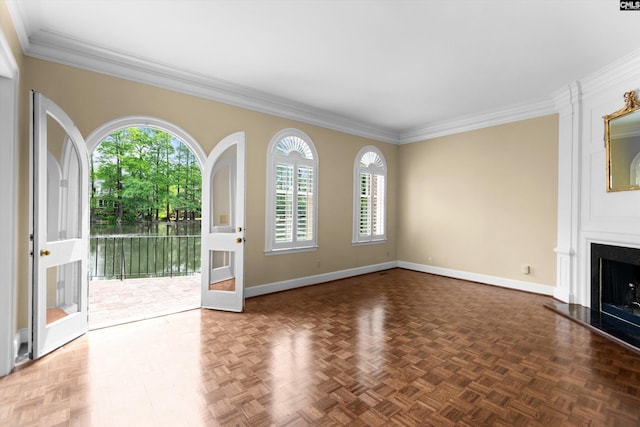 unfurnished living room with baseboards, ornamental molding, and a wealth of natural light