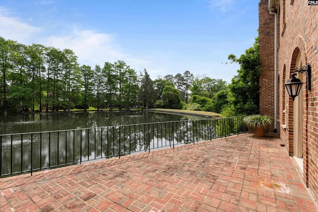 view of patio with a water view