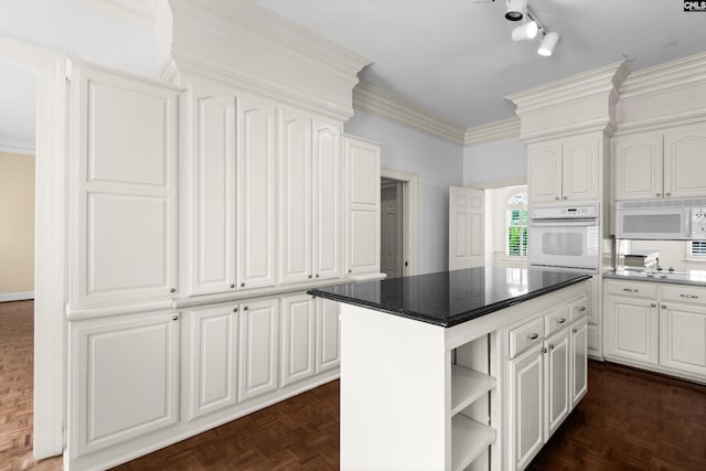 kitchen featuring white appliances, white cabinetry, open shelves, and a center island