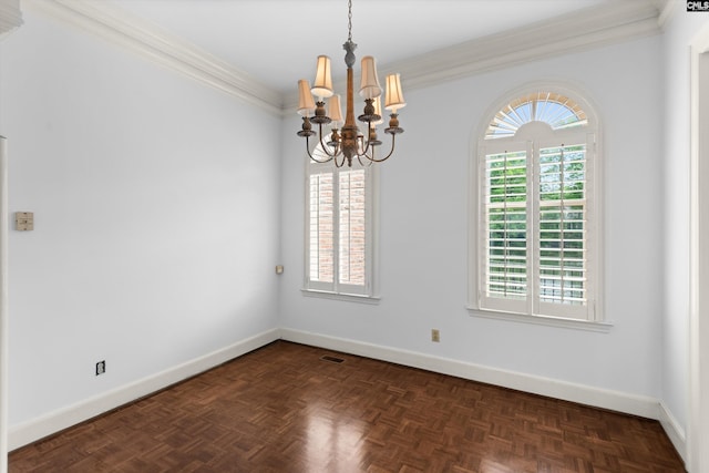 empty room featuring baseboards, crown molding, a notable chandelier, and a wealth of natural light
