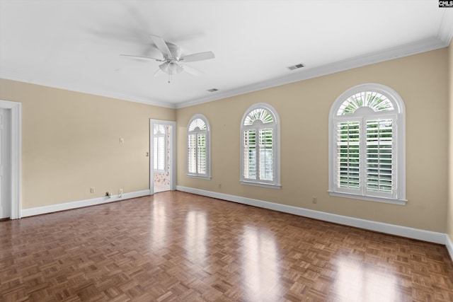 spare room featuring visible vents, a ceiling fan, baseboards, and a wealth of natural light