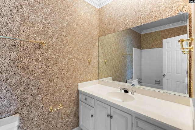 bathroom with vanity, ornamental molding, and toilet