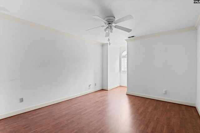spare room featuring crown molding, a ceiling fan, wood finished floors, and visible vents