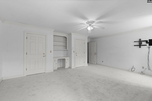unfurnished living room featuring baseboards, ornamental molding, light carpet, and a ceiling fan