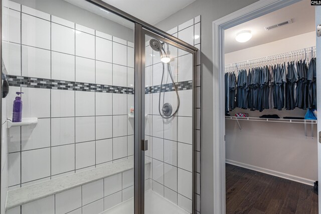 742 Westfield Rd, Lexington, SC 29073 - bathroom featuring a walk in closet, visible vents, a shower stall, wood finished floors, and baseboards