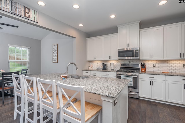 742 Westfield Rd, Lexington, SC 29073 - kitchen featuring dark wood-style flooring, light stone countertops, a sink, appliances with stainless steel finishes, and backsplash