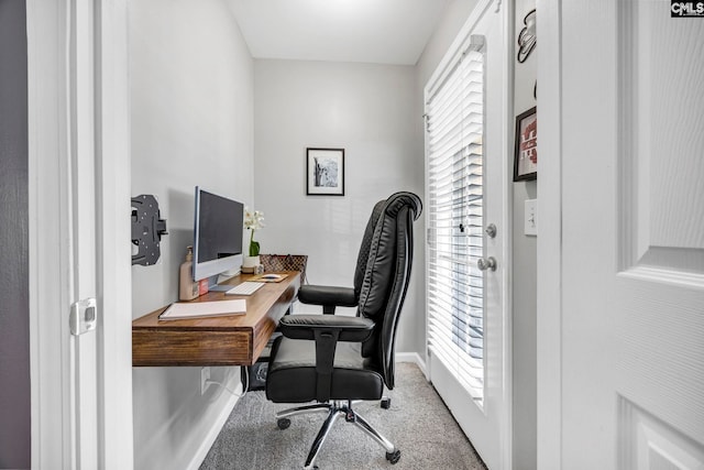 carpeted office featuring baseboards