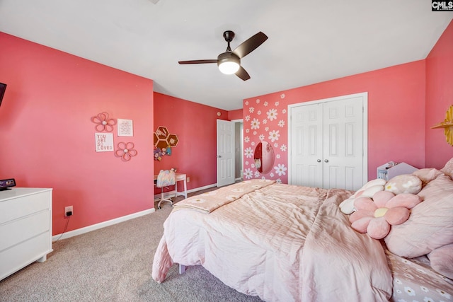 carpeted bedroom featuring a closet, a ceiling fan, and baseboards