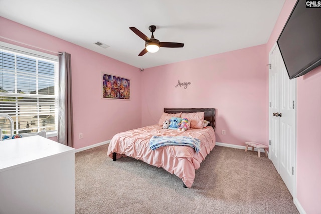 bedroom with baseboards, visible vents, light carpet, and ceiling fan