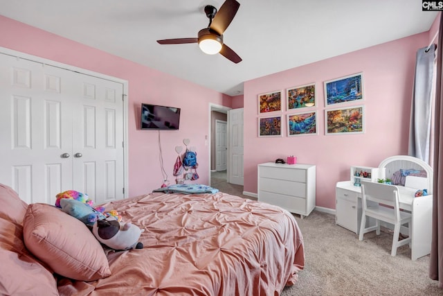 carpeted bedroom featuring a closet, a ceiling fan, and baseboards