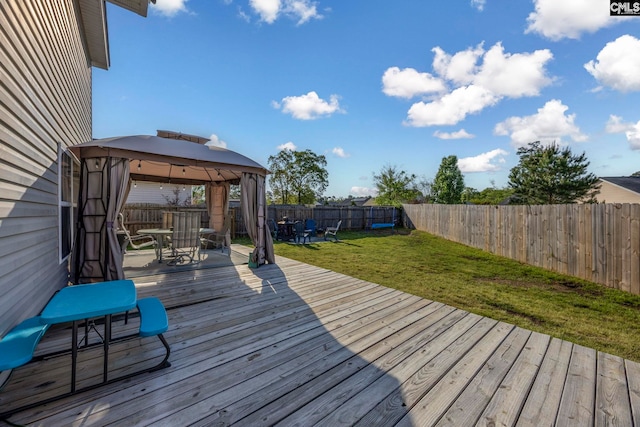 wooden deck with a lawn, a gazebo, a fenced backyard, and outdoor dining space