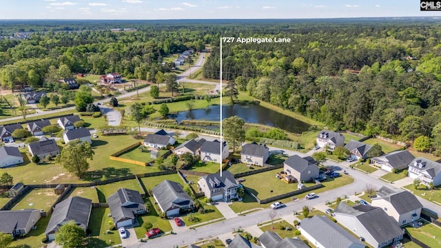birds eye view of property featuring a water view, a view of trees, and a residential view